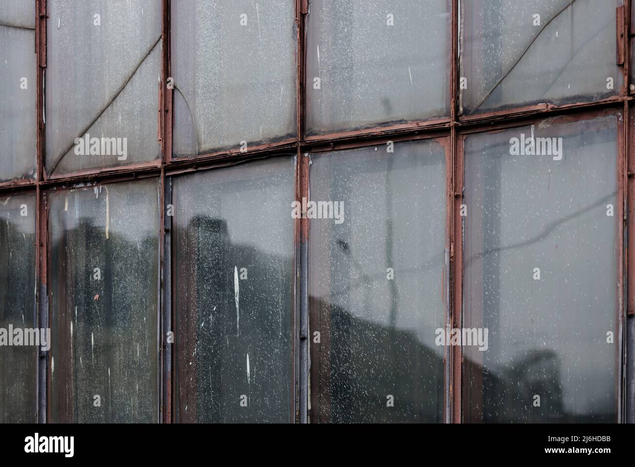 Rusted and cracked warehouse. old factory windows Stock Photo