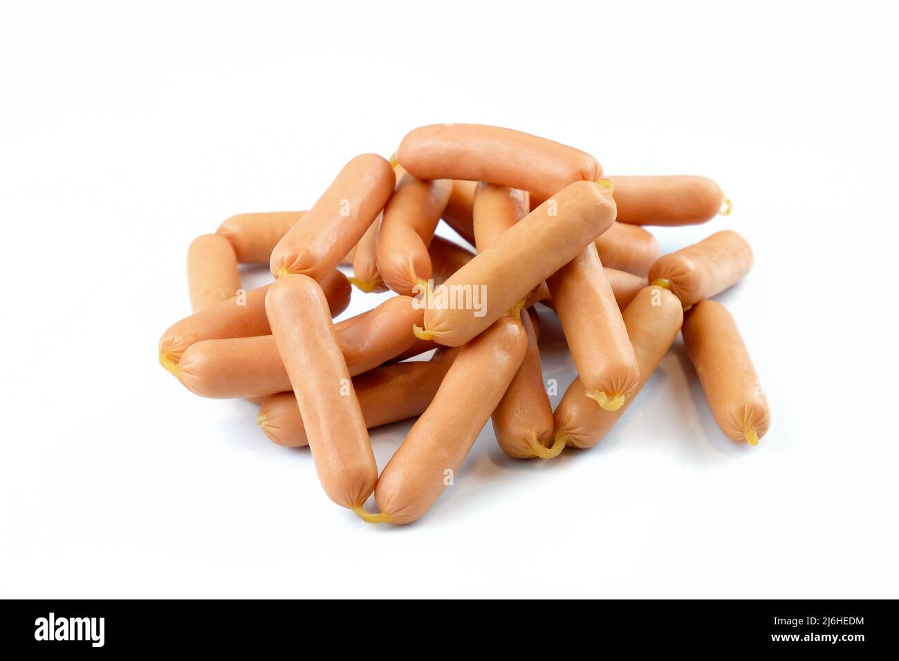 Small thin sausages on a white background. Chicken sausages in a