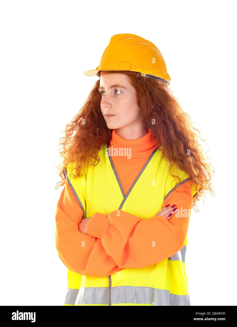 Portrait of attractive cheerful lucky red-haired girl with helmet and reflective vest isolated on a white background Stock Photo