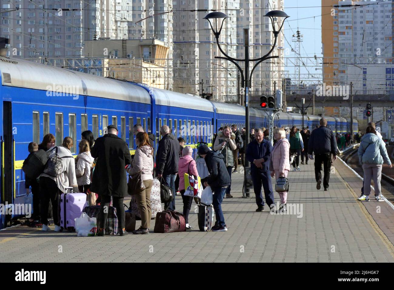 ODESA, UKRAINE - APRIL 25, 2022 - People leaving the city due to the Russian invasion stay on the platform before the departure of an evacuation train Stock Photo