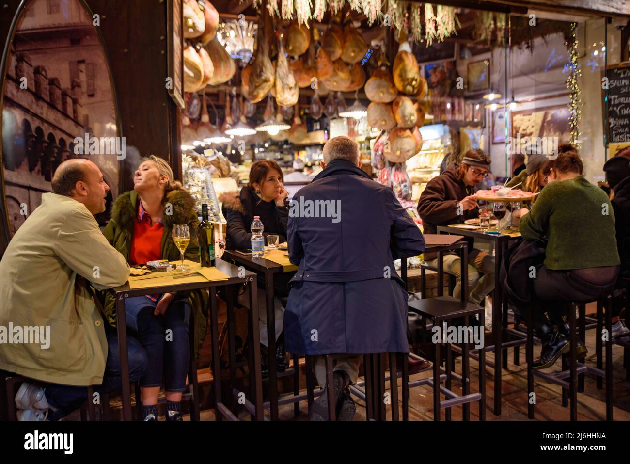 People eating and drinking on the street in Bologna, Italy Stock Photo