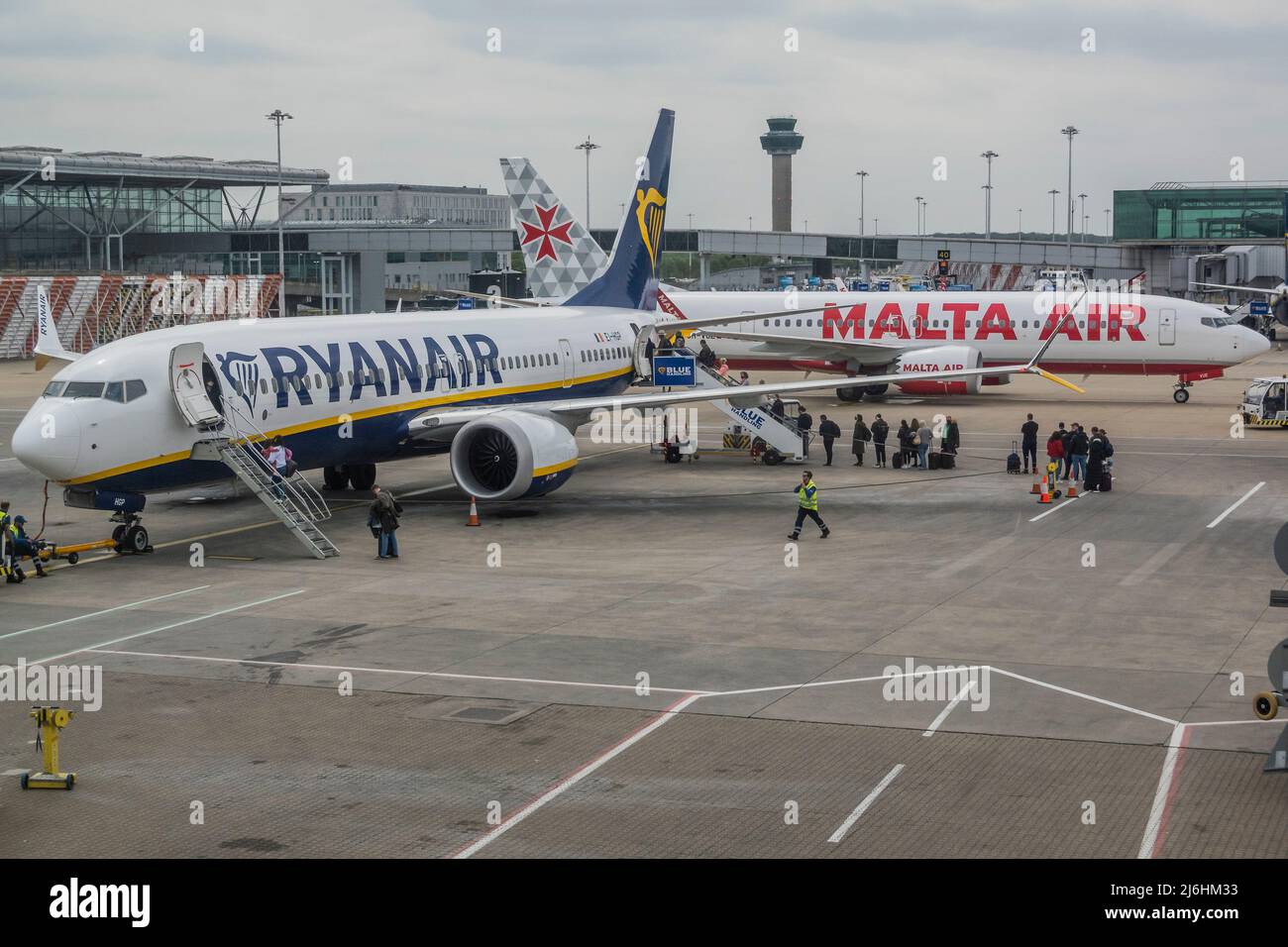 London, UK. 28 Apr 2022. As usual Ryanair passengers have to walk outside to the plane and cue on the tarmac -  Ryanair plane loads Travel through Stansted Airport on the May Bank Holiday. Credit: Guy Bell/Alamy Live News Stock Photo