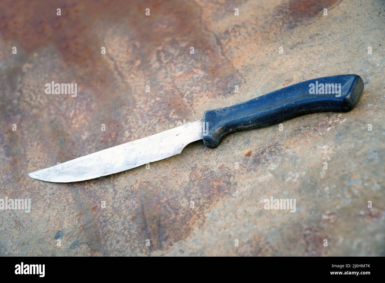 An old blunt kitchen knife with a black plastic handle Stock Photo Alamy