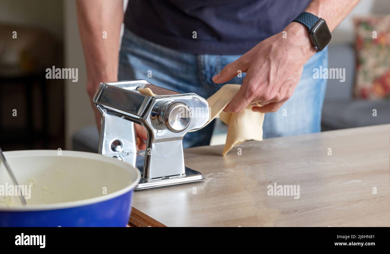 https://c8.alamy.com/comp/2J6HN81/pasta-maker-machine-fresh-pasta-homemade-preparation-male-hand-making-dough-phylo-close-up-view-2J6HN81.jpg