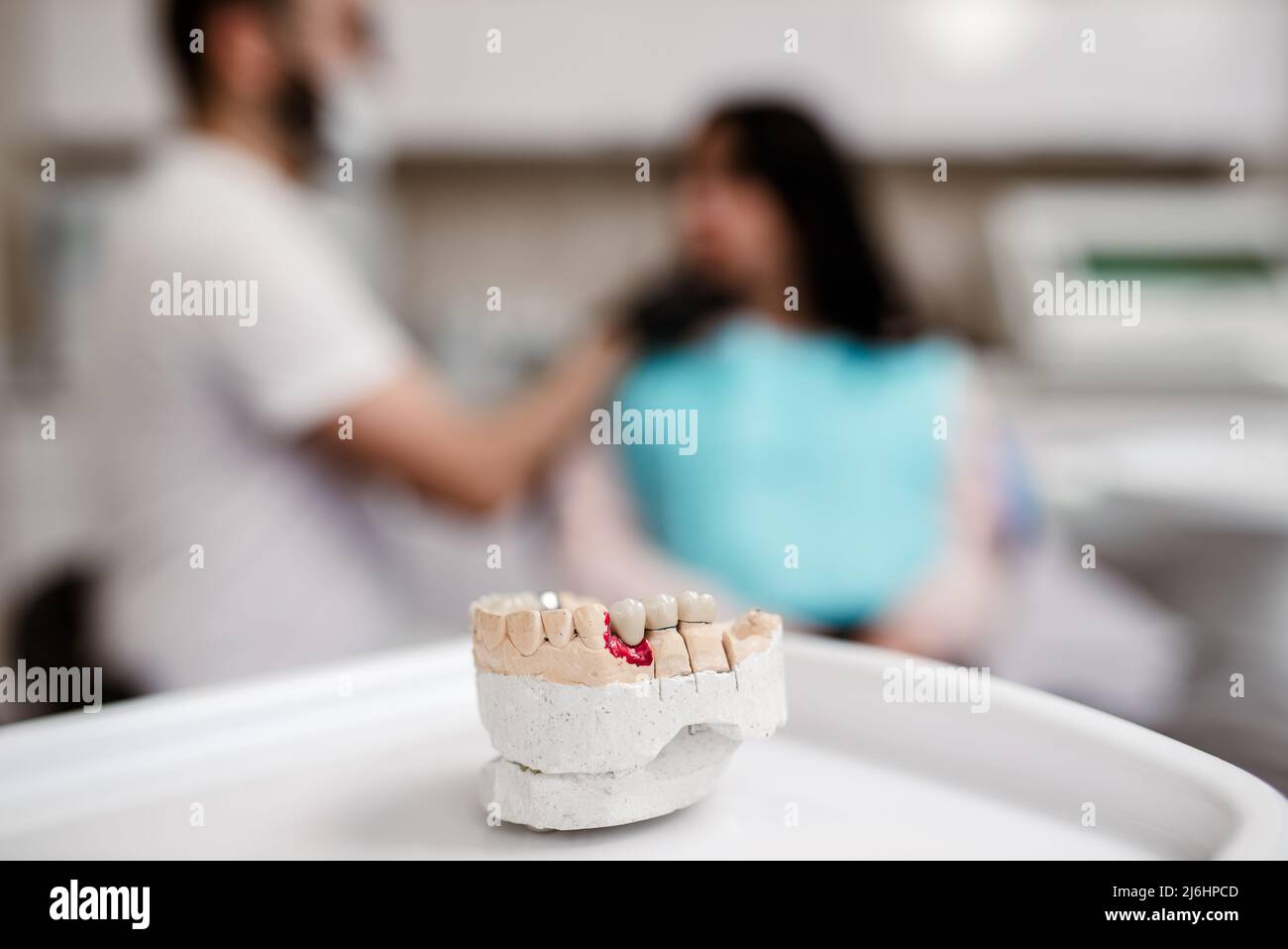 Dental mold showing the teeth of the upper and lower jaw with dental tools Stock Photo