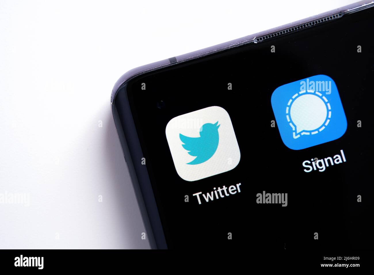 The smartphone corner with Twitter and Signal apps macro photo. Twitter plan to use the encryption as in messaging Signal app. Stafford, United Kingdo Stock Photo