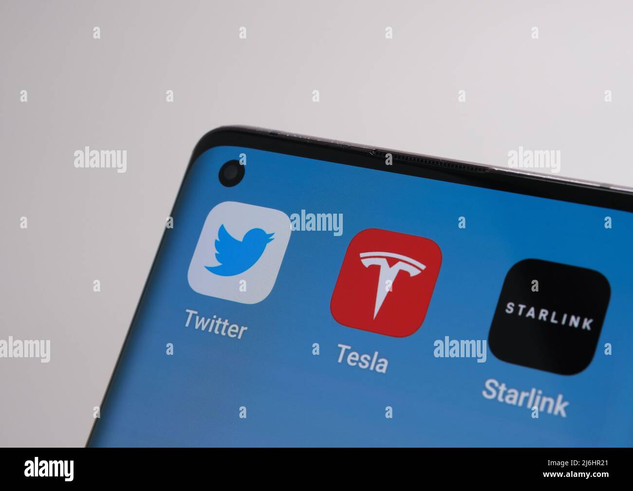 The smartphone with Twitter, Tesla and Starlink apps. Concept for Elon Musk asset ownewship. Stafford, United Kingdom, May 2, 2022 Stock Photo