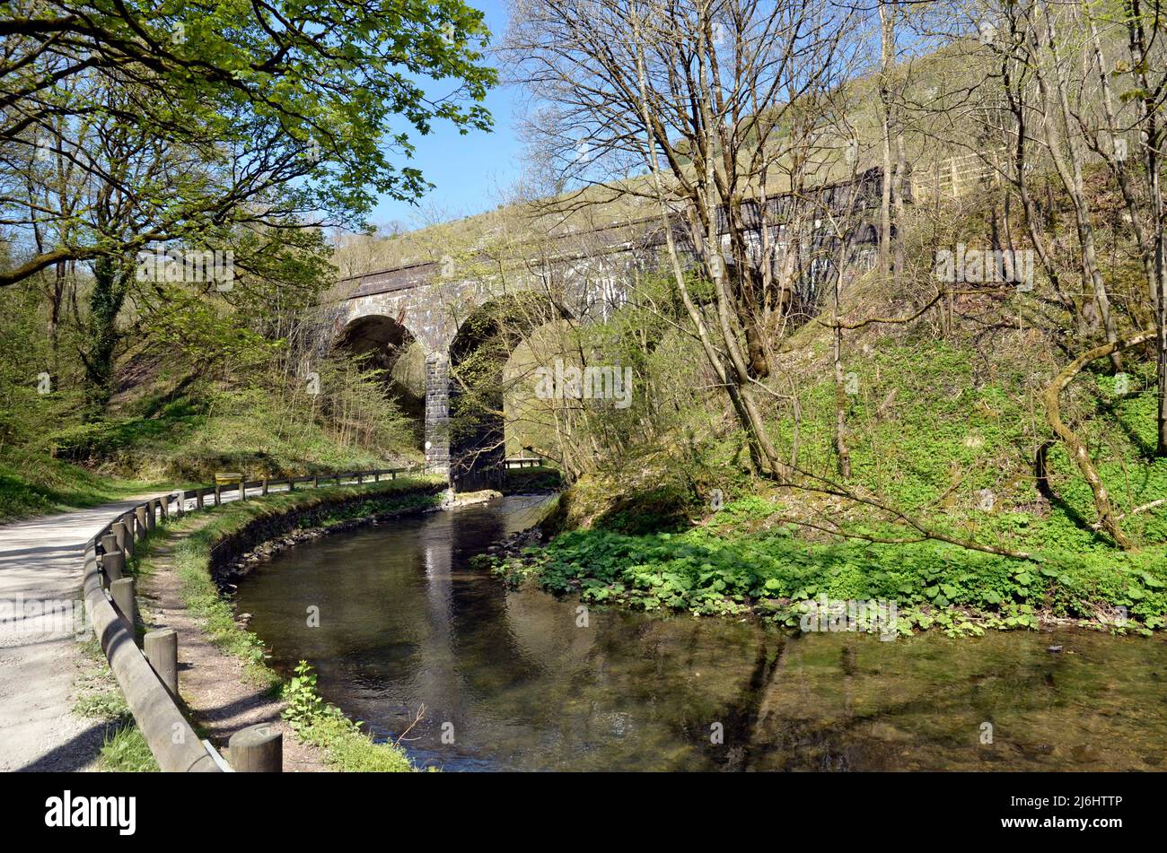 A railway viaduct over the Monsal Trail cycleway along the River Wye near Buxton, Derbyshire Stock Photo
