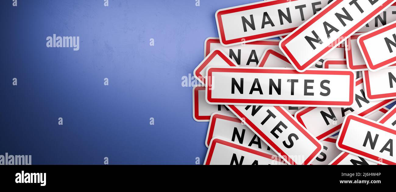 Multiple Nantes city-limit signs on a heap. Nantes is located in the Loire-Atlantique department, France. The typical white city limit sign with a red Stock Photo