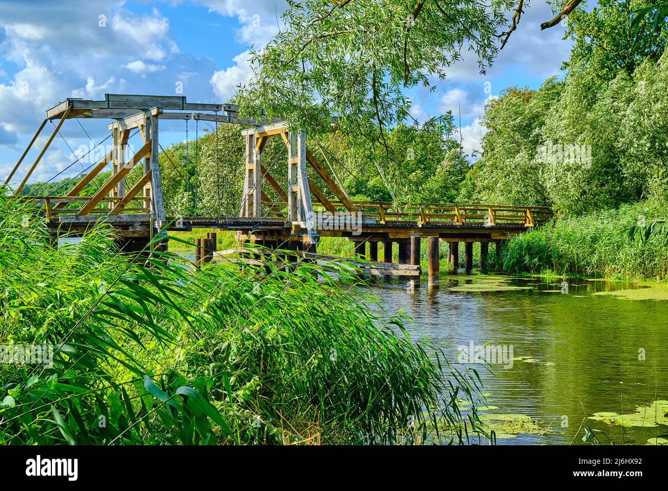 Listed wooden bascule bridge spanning the Trebel near Nehringen, Mecklenburg-Western Pomerania, Germany. Stock Photo
