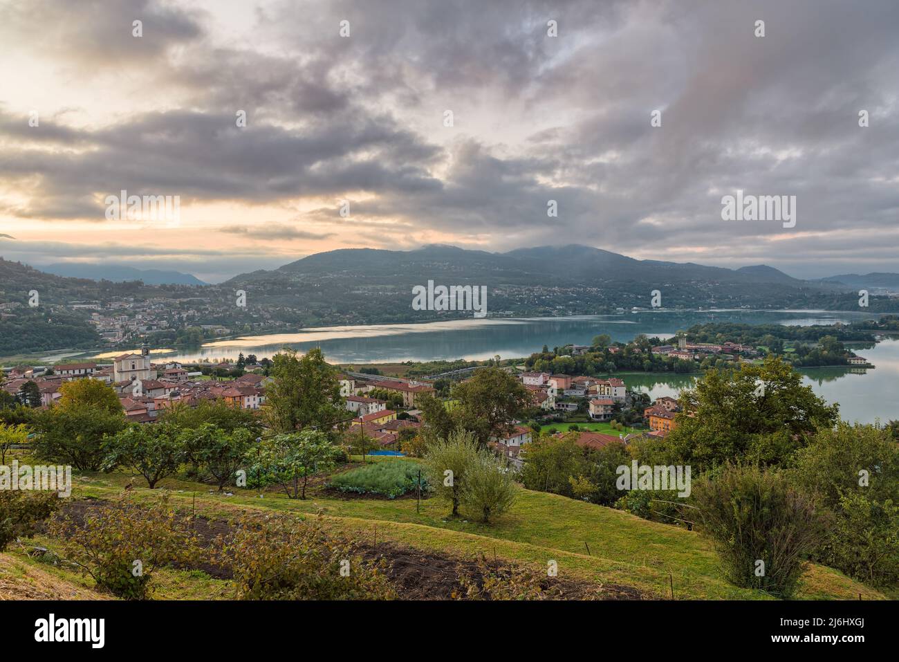 Beautiful Italian lake at sunrise. Aerial view of lake Annone or lake Oggiono. Northern Italy. Aerial panorama of a lake in the morning Stock Photo