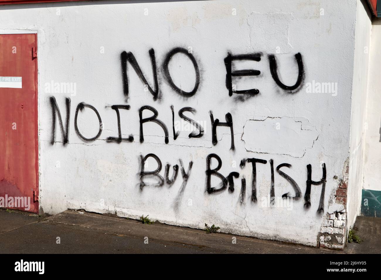 'No EU No Irish Buy British' Anti Eu Anti Irish pro british brexit graffitti sprayed on a wall near a supermarket on the lower Newtownards Road, East Stock Photo