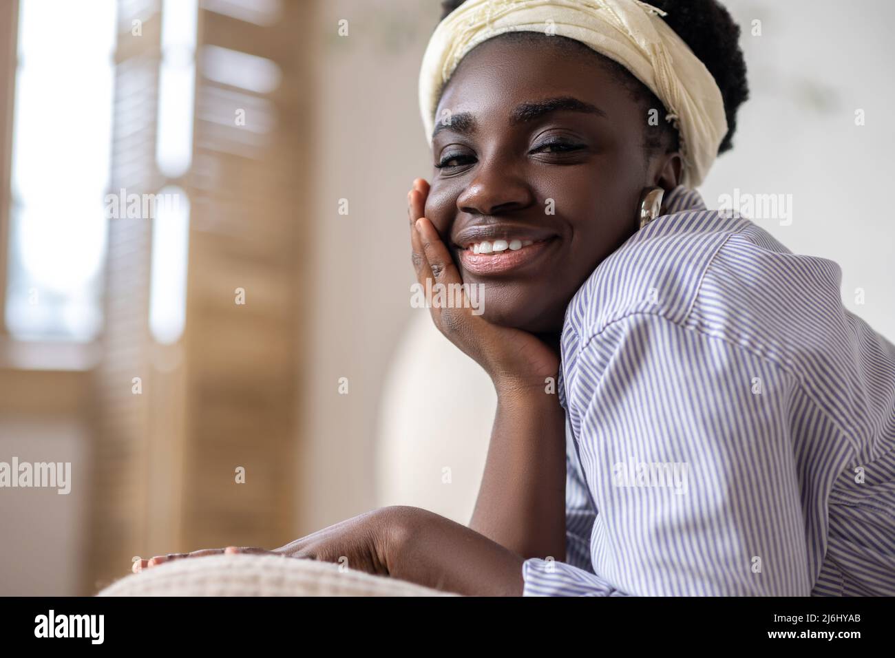 African american woman laying on bed and looking dreamy Stock Photo