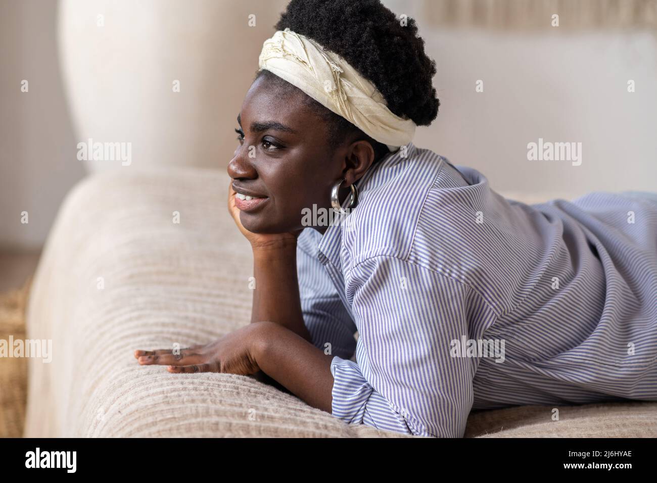 African american woman laying on bed and looking dreamy Stock Photo