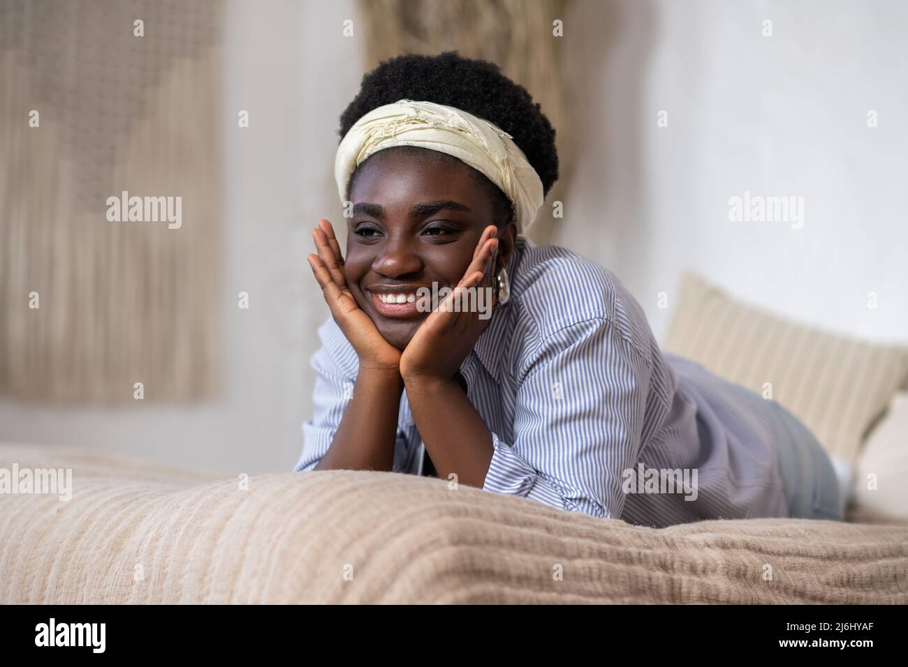 African american woman laying on bed and looking dreamy Stock Photo