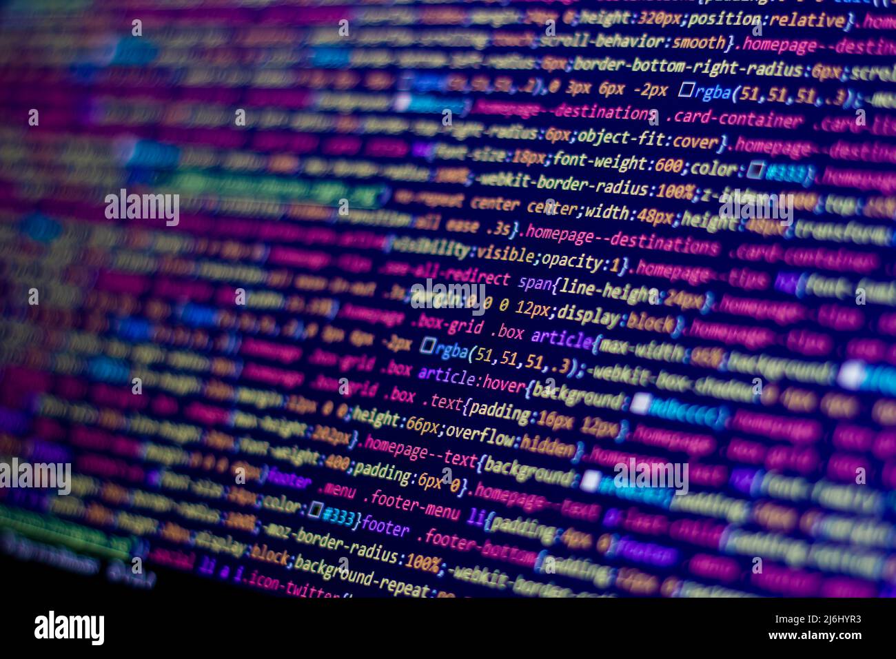 side view computer screen with pink or yellow code lines. digital ...