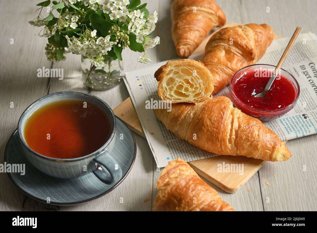 Closeup Table with Fresh baked croissant and tea Stock Photo