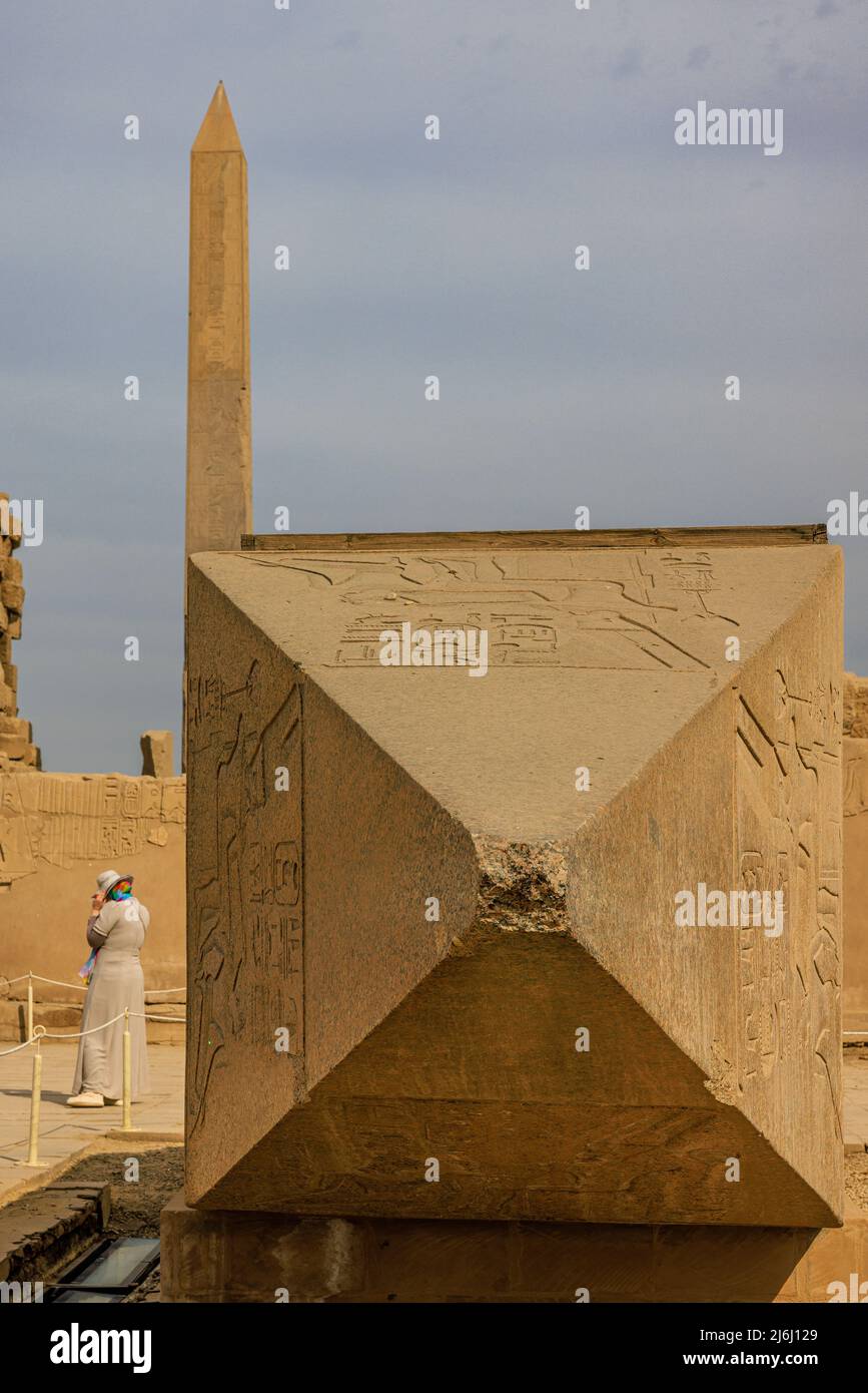 close up of the top of the broken obelisk of hatshepsut (now re-erected) with the standing obelisk towering in the background Stock Photo