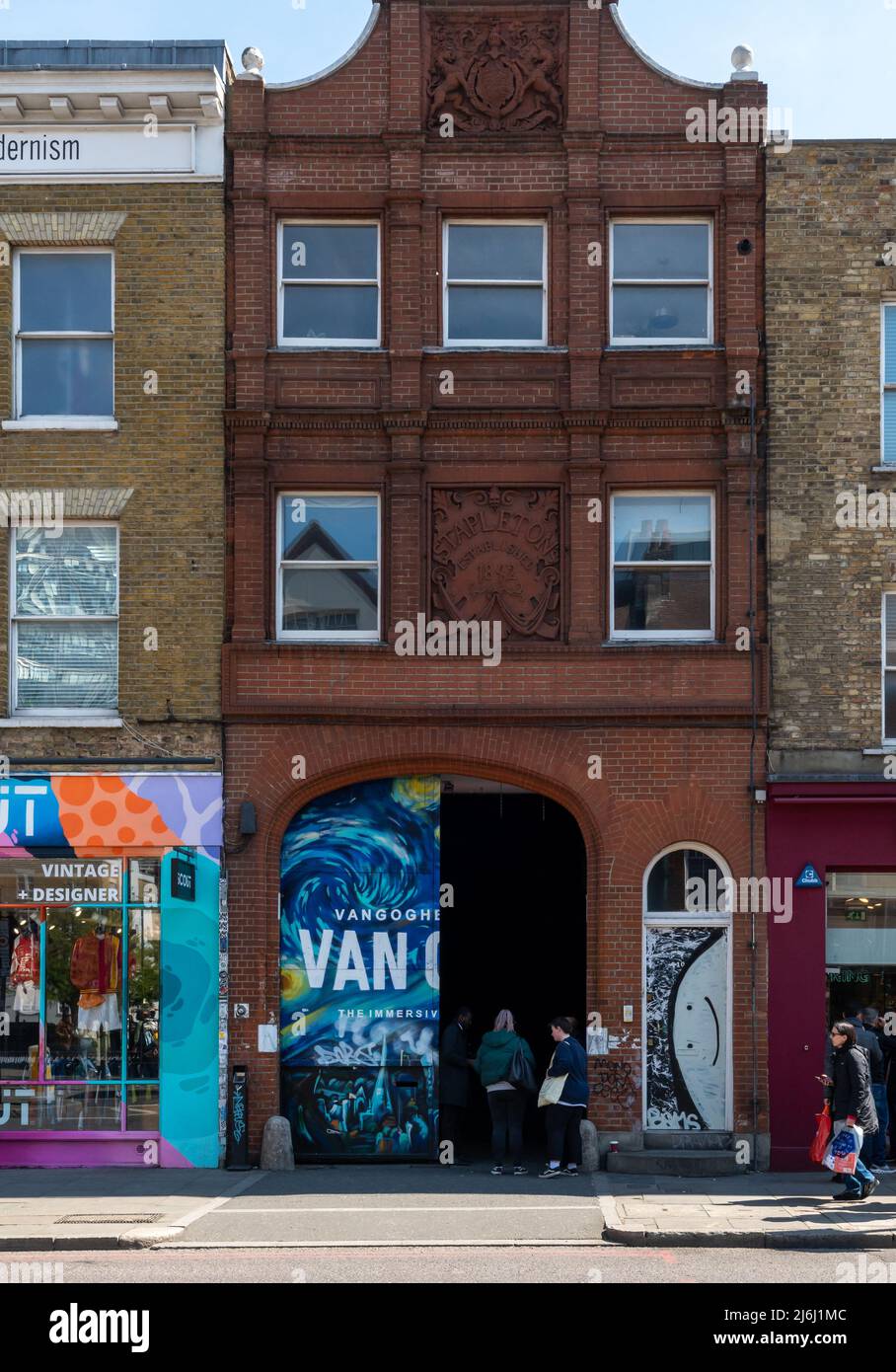 London Shoreditch, UK. 30 April 2022. Outside street view at entrance gate with people entering
