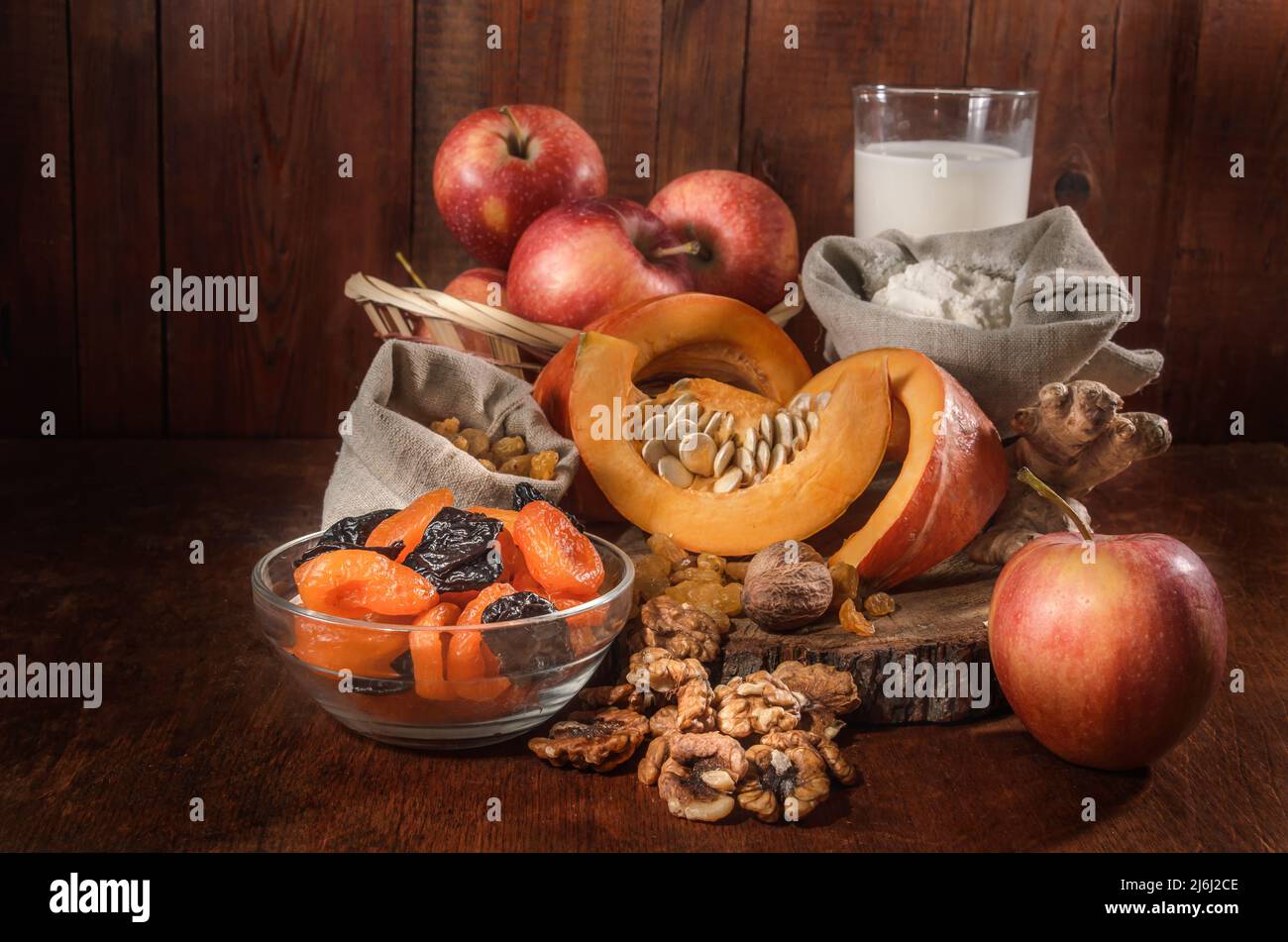 pumpkin and ingredients for pumpkin casserole with nuts and dried fruits on a dark background Stock Photo