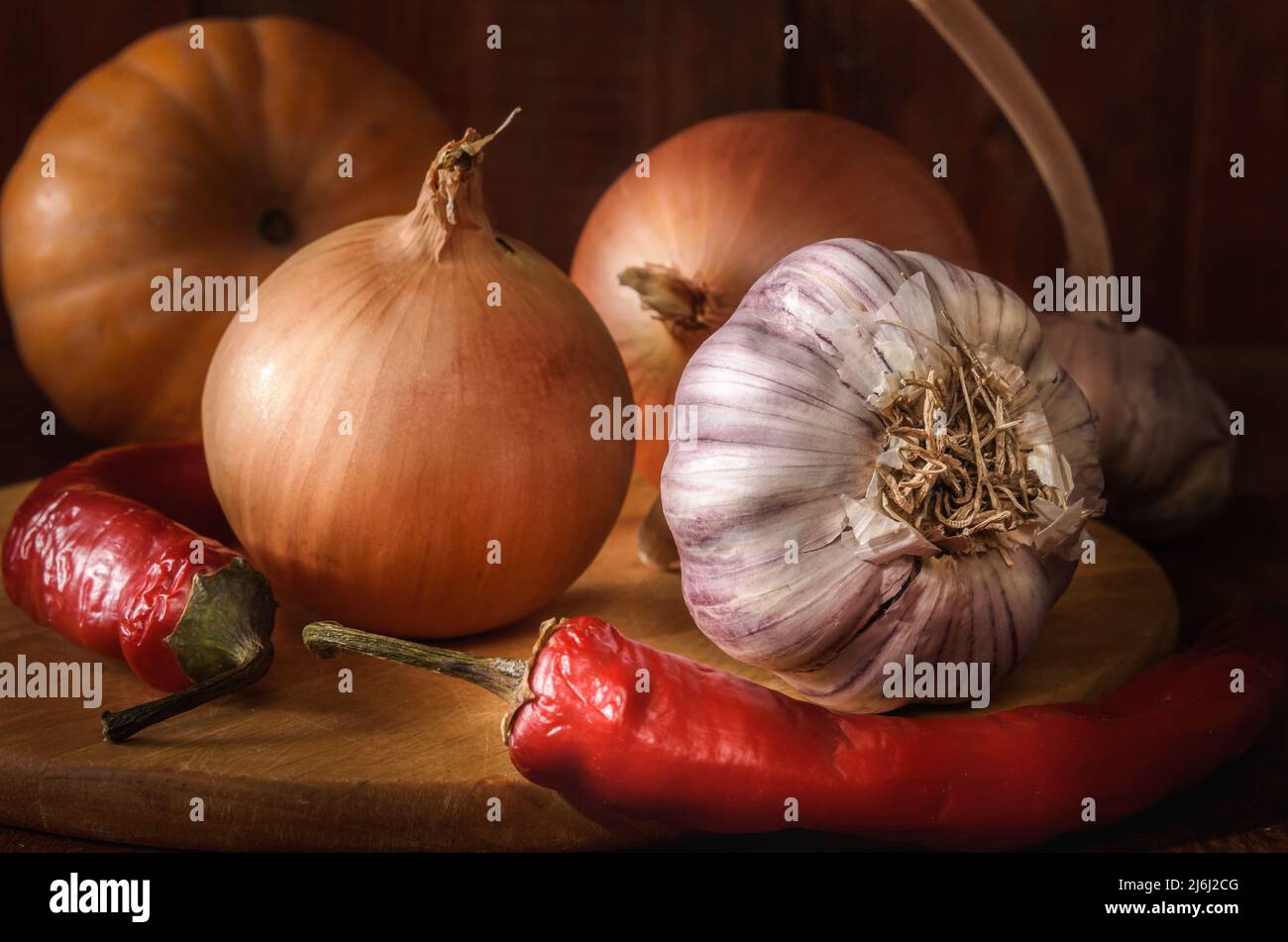 garlic and other vegetables on a dark wooden background Stock Photo