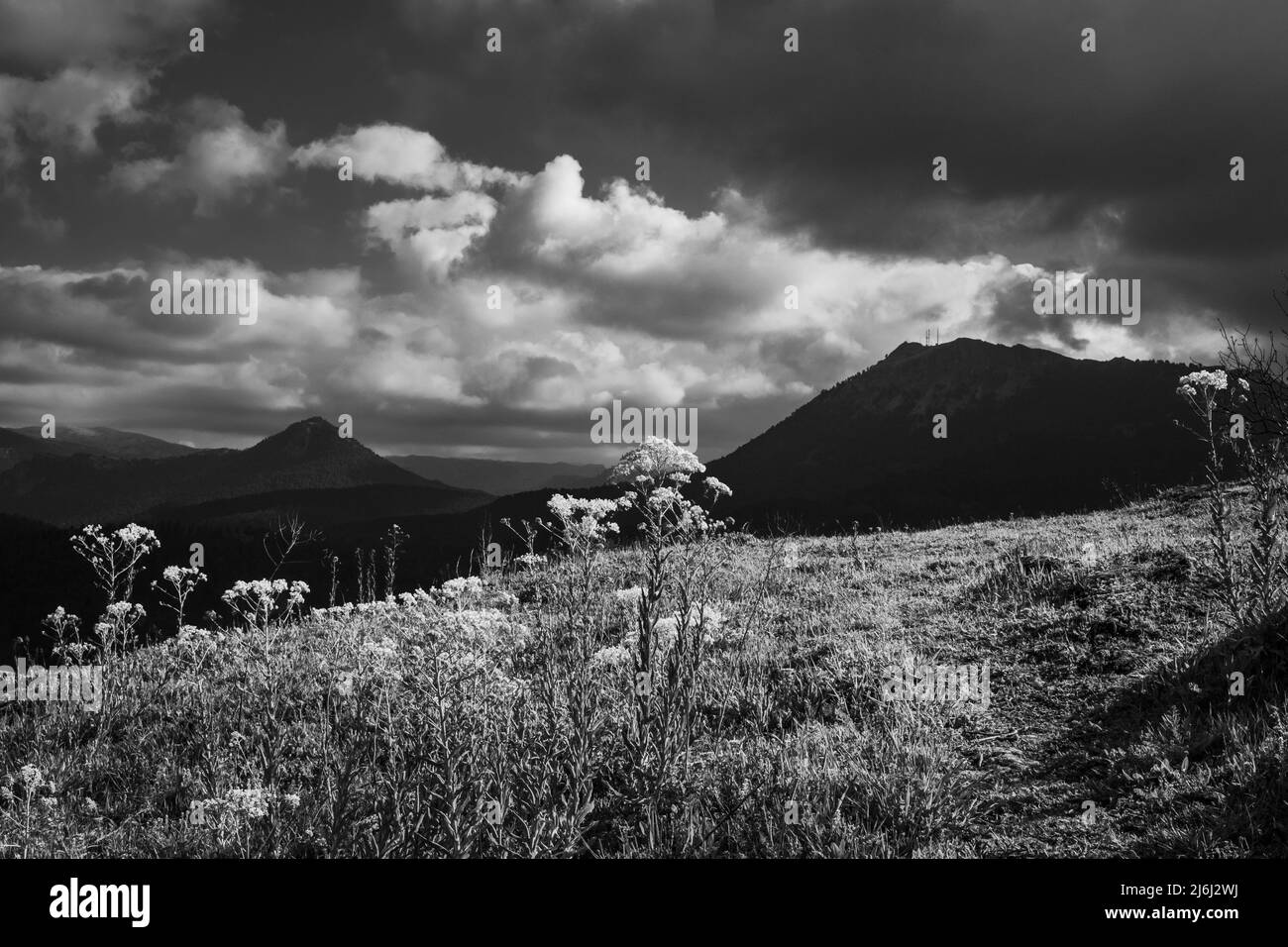 A black and white mountain landscape with dramatic sky and high ...