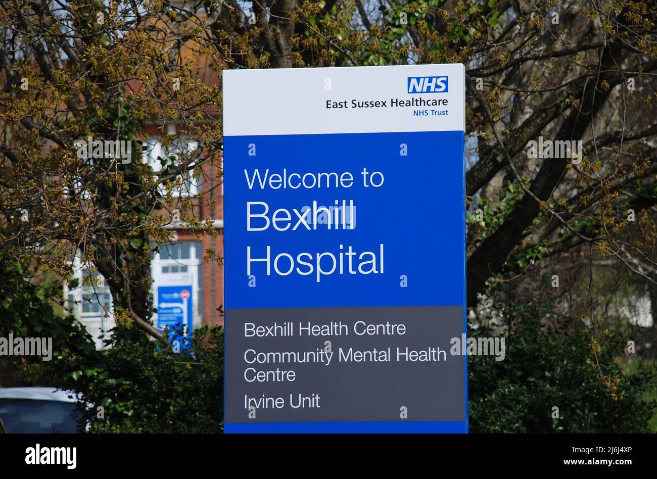 Signage outside the entrance to Bexhill Hospital in East Sussex, England on April 12, 2022. Opened in 1933, it became part of the National Health Service in 1948. Stock Photo