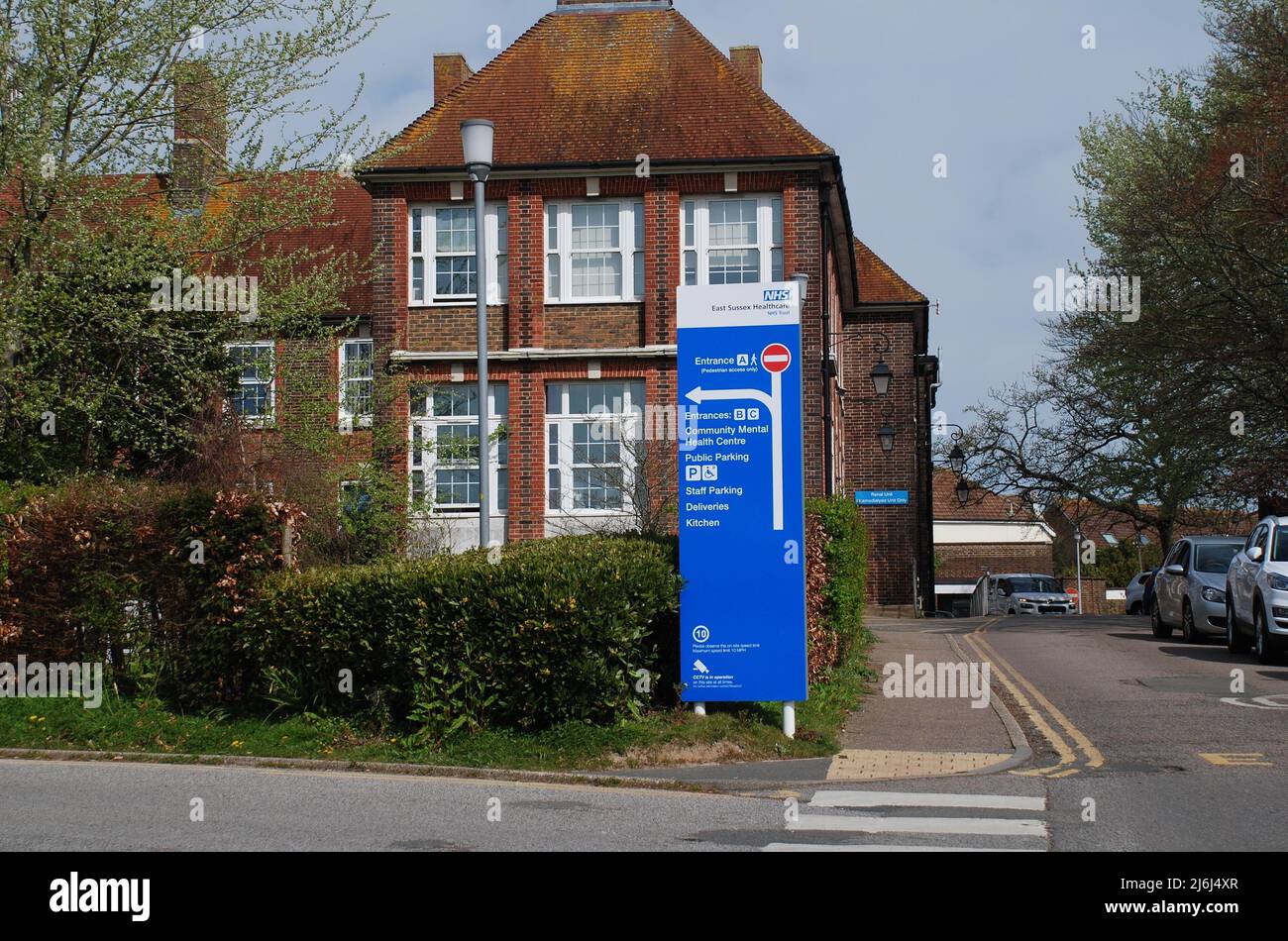 Signage outside the entrance to Bexhill Hospital in East Sussex, England on April 12, 2022. Opened in 1933, it became part of the National Health Service in 1948. Stock Photo