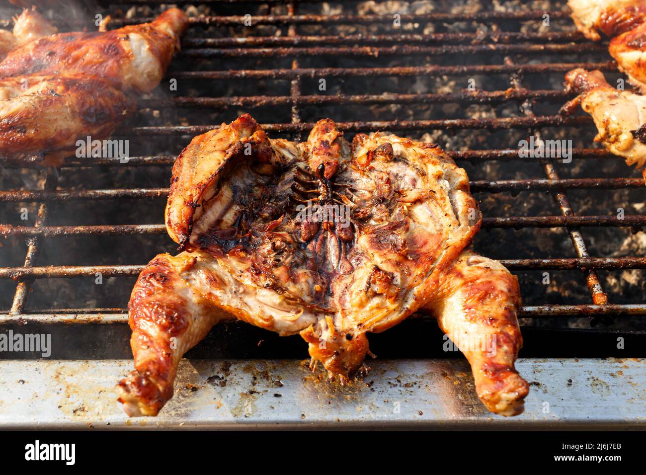 Local street food, delicious charcoal grill whole chicken barbecue in
