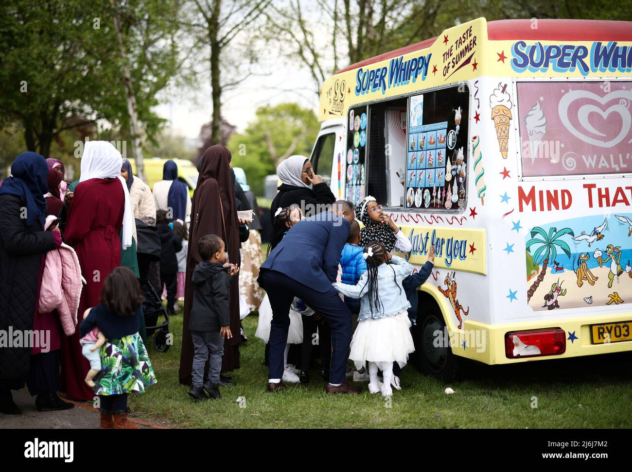 People queue for an ice cream truck during Eid alFitr celebrations at