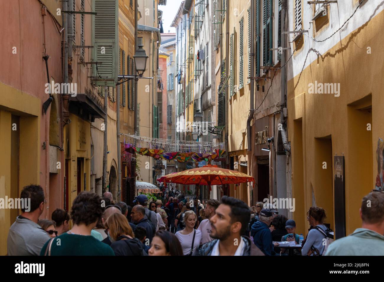 Crowds in a narrow street in Nice Old Town, France. Stock Photo