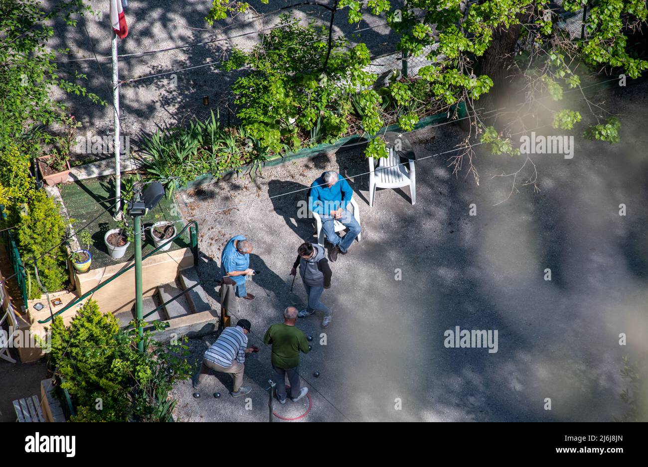 A shot looking down on Men playing boules in Nice France. Stock Photo