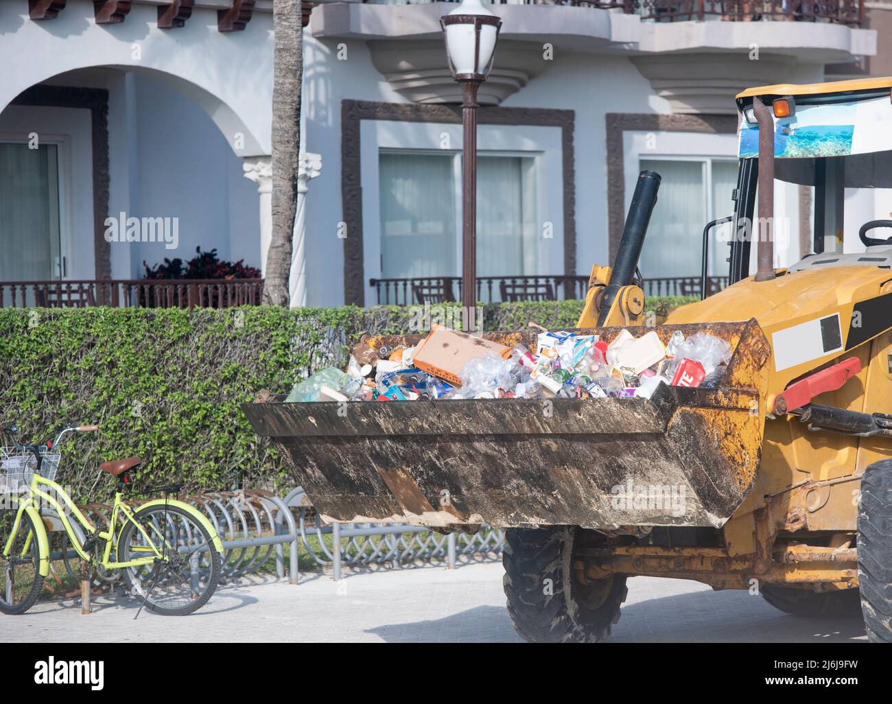 Close-up of a bulldozer hauling trash on an urban street in Mexico Stock Photo