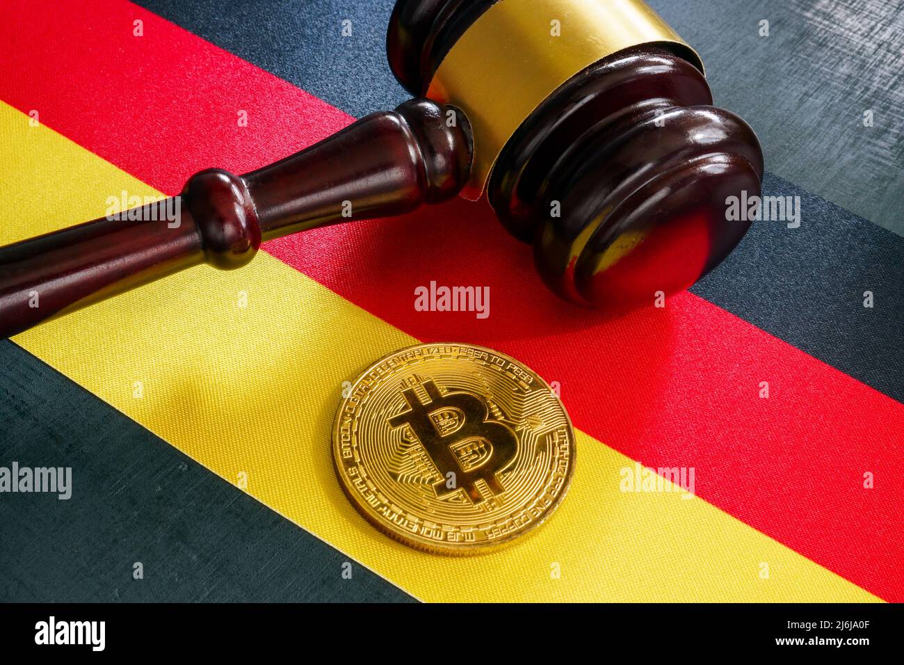 Flag, gavel and coin. Cryptocurrency regulations in Germany. Stock Photo