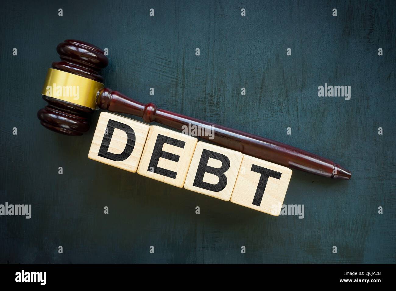 Gavel and debt from cubes. Bankruptcy concept. Stock Photo