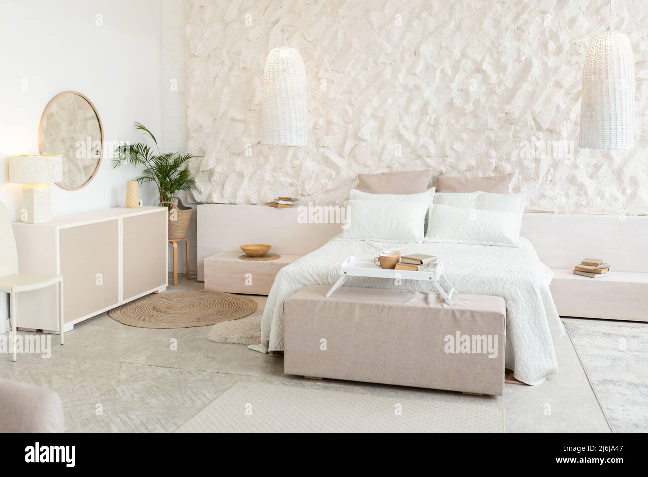 Bedroom Background, Spacious Room With Cozy Bed And White Walls Stock Photo