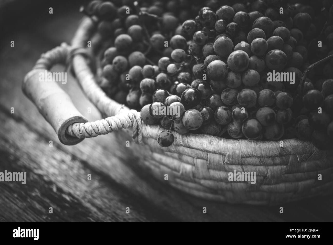 Grapes on the basket on the wooden table Stock Photo