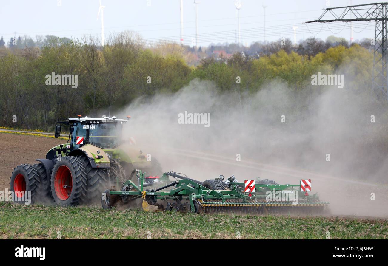 02 May 2022, MecklenburgWestern Pomerania, Clausdorf A tractor drags