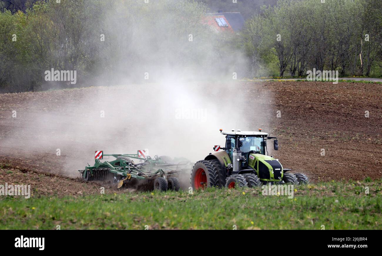 02 May 2022, MecklenburgWestern Pomerania, Clausdorf A tractor drags