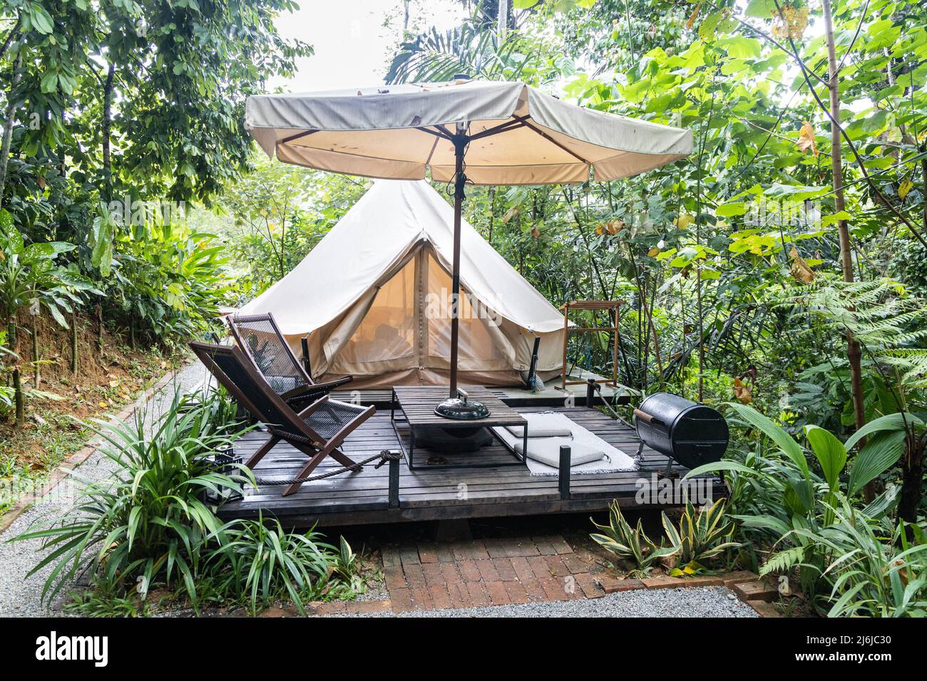 Luxury glamping tent on wooden deck lifestyle in the tropical woods Stock Photo