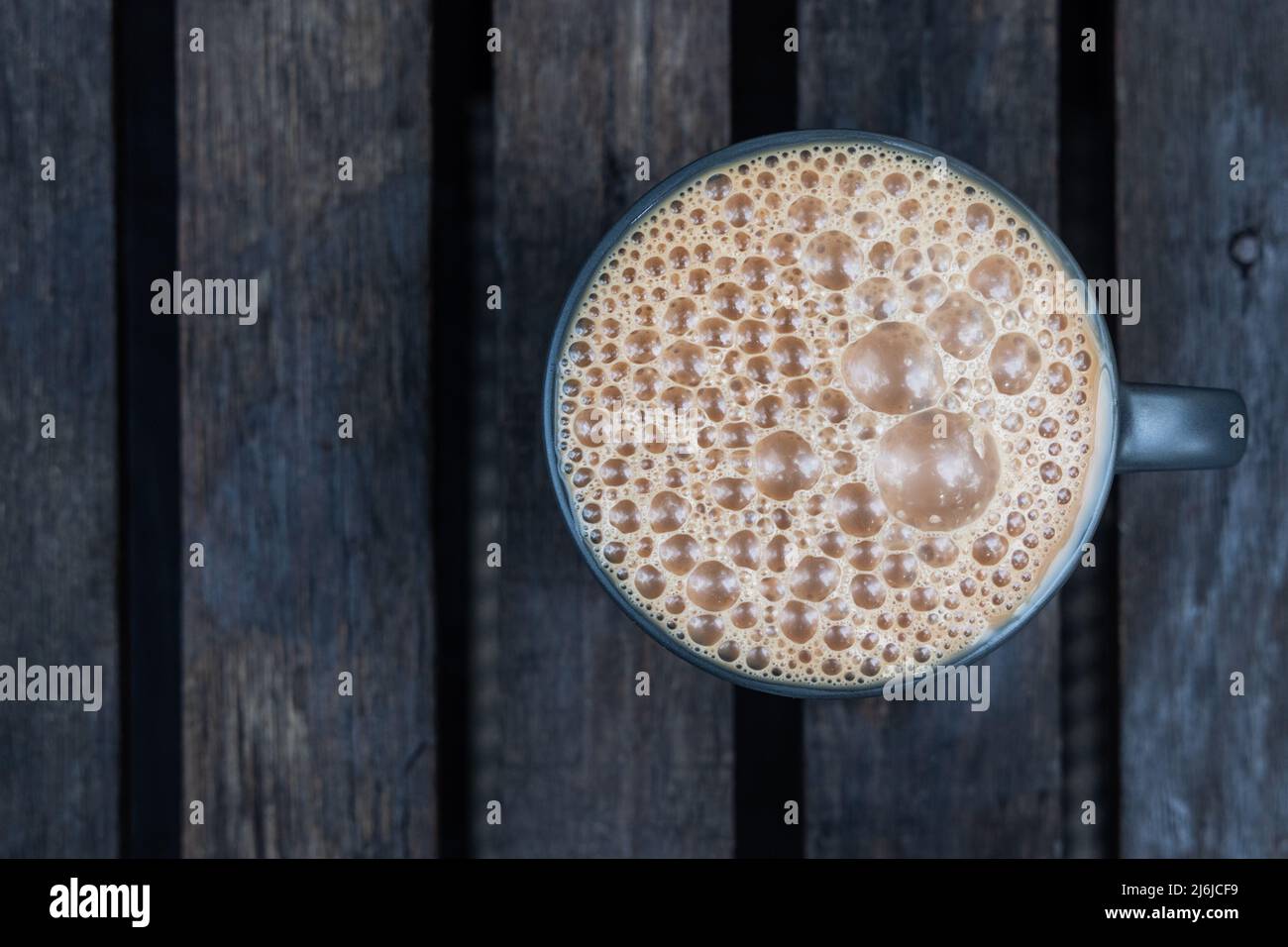 Ovverhead view of Teh Tarik. It is infused black tea with milk served in thick froth. Popular drinks in Malaysia Stock Photo