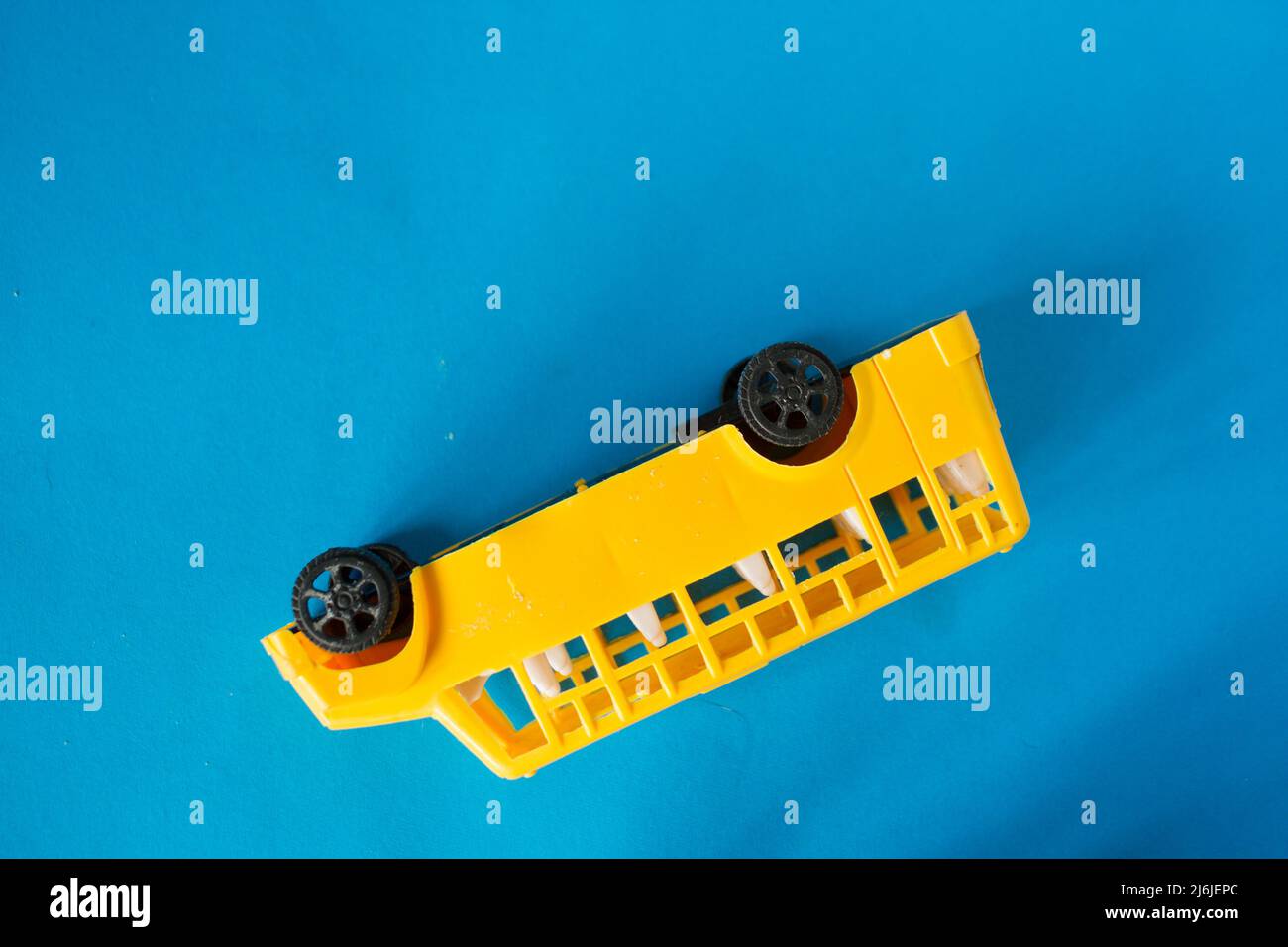 Accident with shcool bus concept. Toy bus upside down Stock Photo