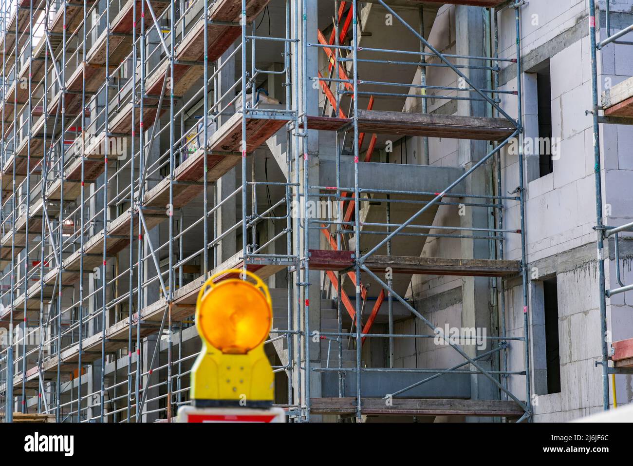 Shell of an apartment building with scaffolding and warning light in the foreground in Bad Homburg (Vickers - Areal) near Frankfurt on the Main Stock Photo