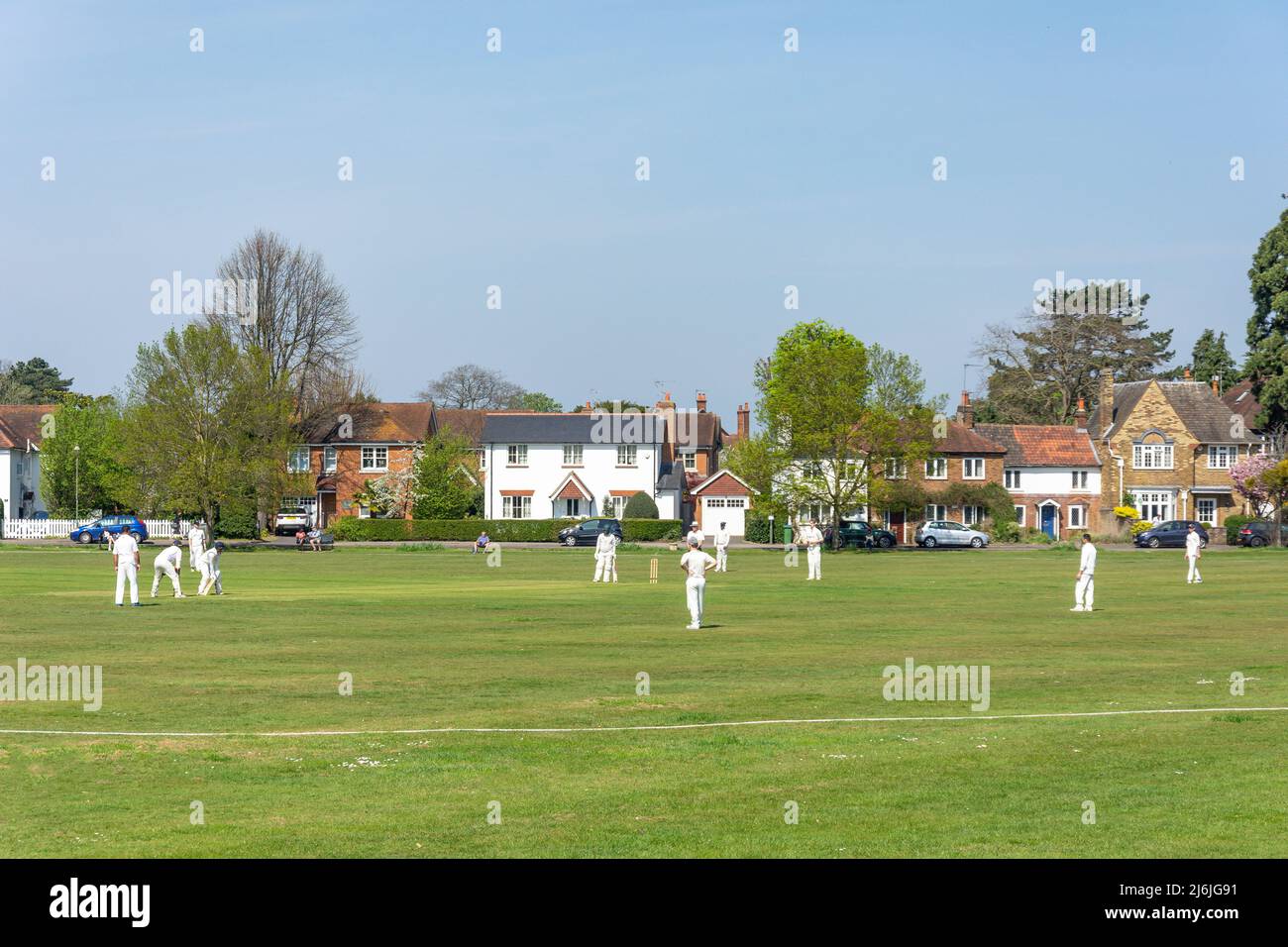 Cricket match on Grigg's Hill Green, Grigg's Hill Road, Thames Ditton, Surrey, England, United Kingdom Stock Photo