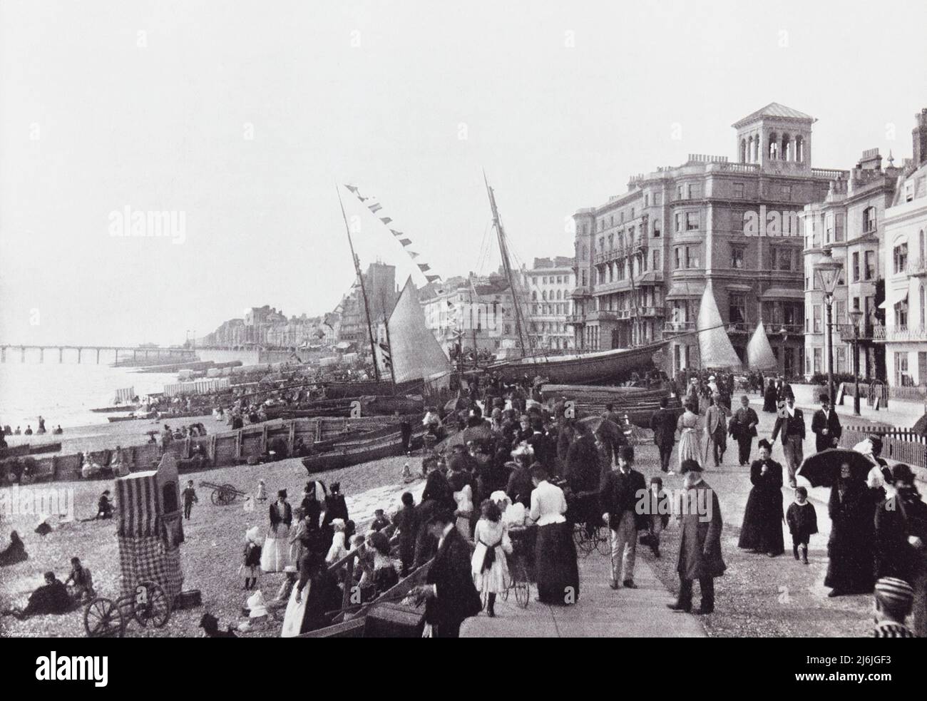 Hastings, East Sussex, England, showing the promenade and the pier in the 19th century.  From Around The Coast,  An Album of Pictures from Photographs of the Chief Seaside Places of Interest in Great Britain and Ireland published London, 1895, by George Newnes Limited. Stock Photo