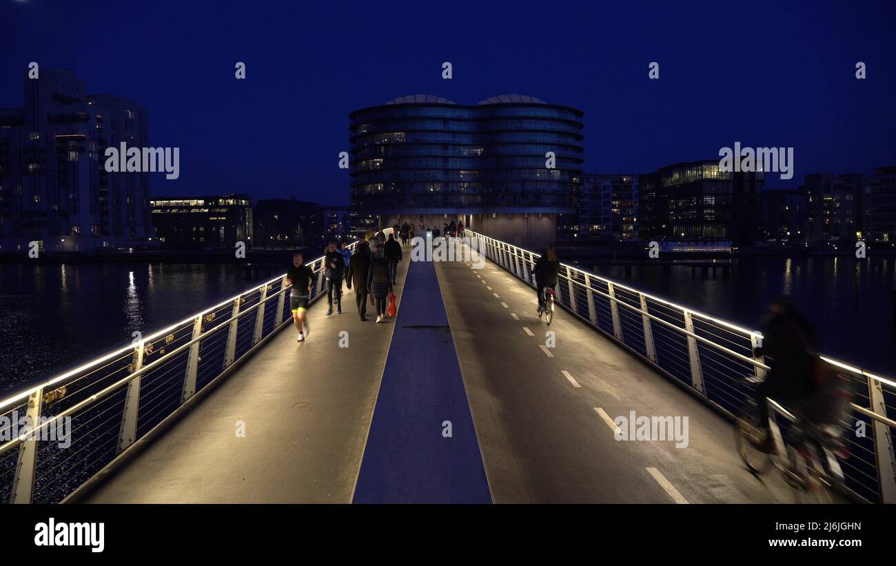 February 18, 2019. Denmark, Copenhagen. The pedestrian bridge is divided into two parts: a bicycle road and a hiking path. City night view with Stock Photo