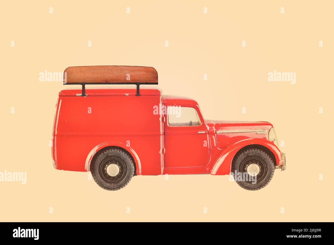 Retro styled image of a vintage small delivery van with wooden empty signboard on top Stock Photo