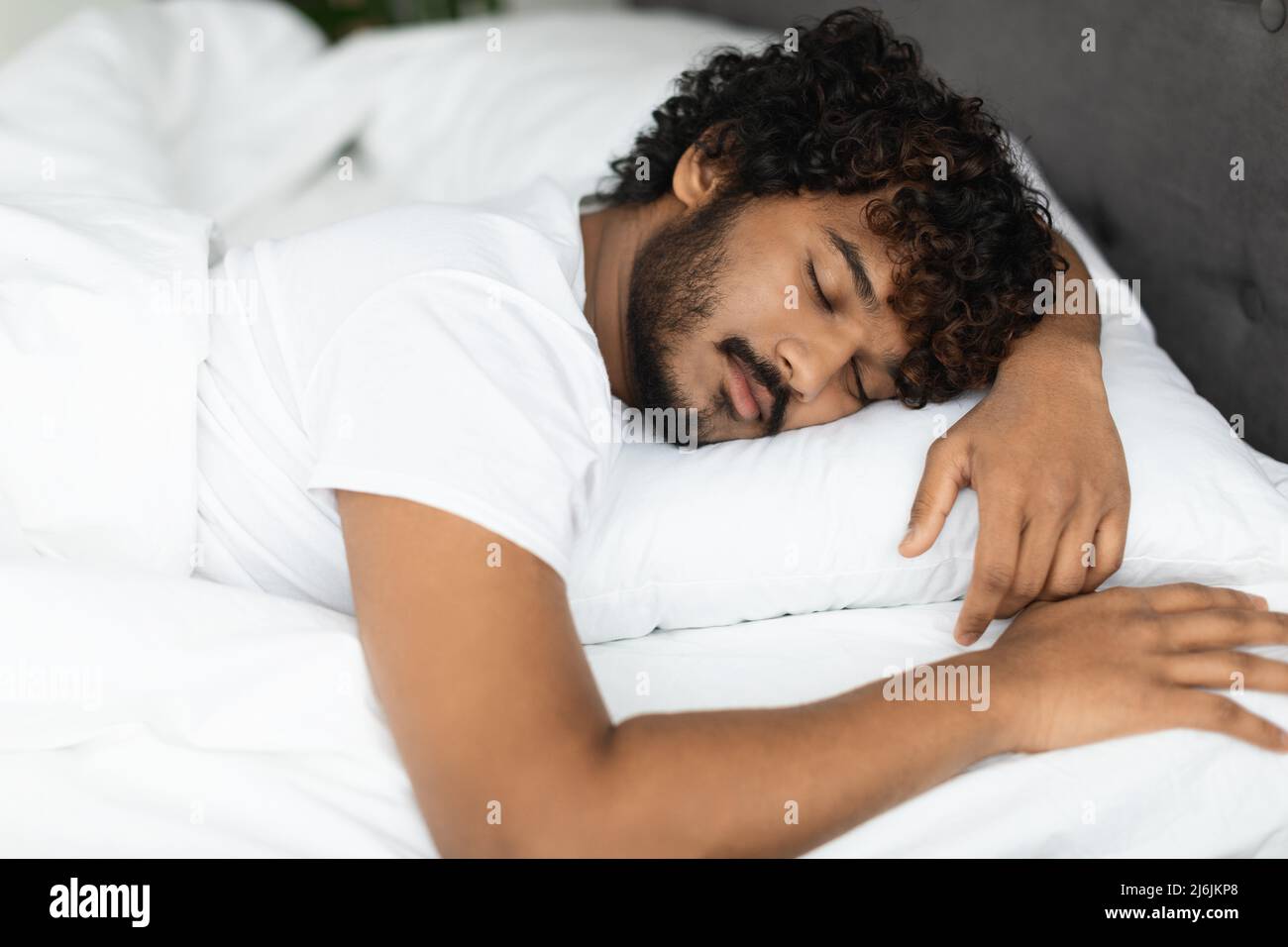 Closeup portrait of peaceful indian guy sleeping in bed Stock Photo Alamy