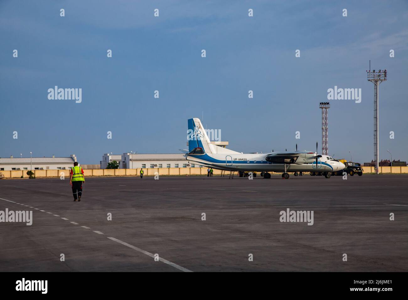 Aktau, Kazakhstan - May 21, 2012: International airport Aktau. Soviet passenger plane Antonov-24 on field. Blue sky. Stock Photo