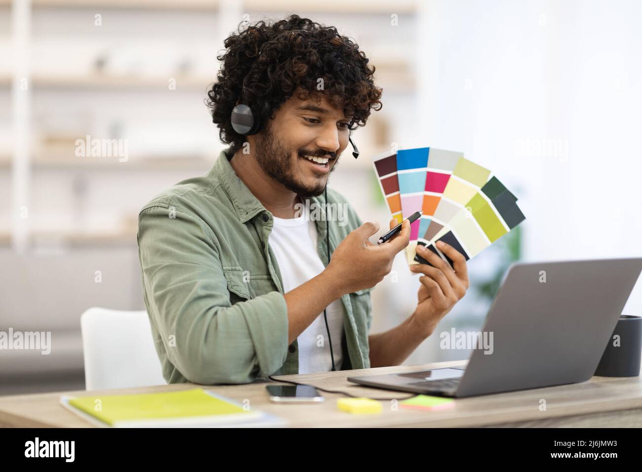 Indian guy designer working from home while pandemic, copy space Stock Photo